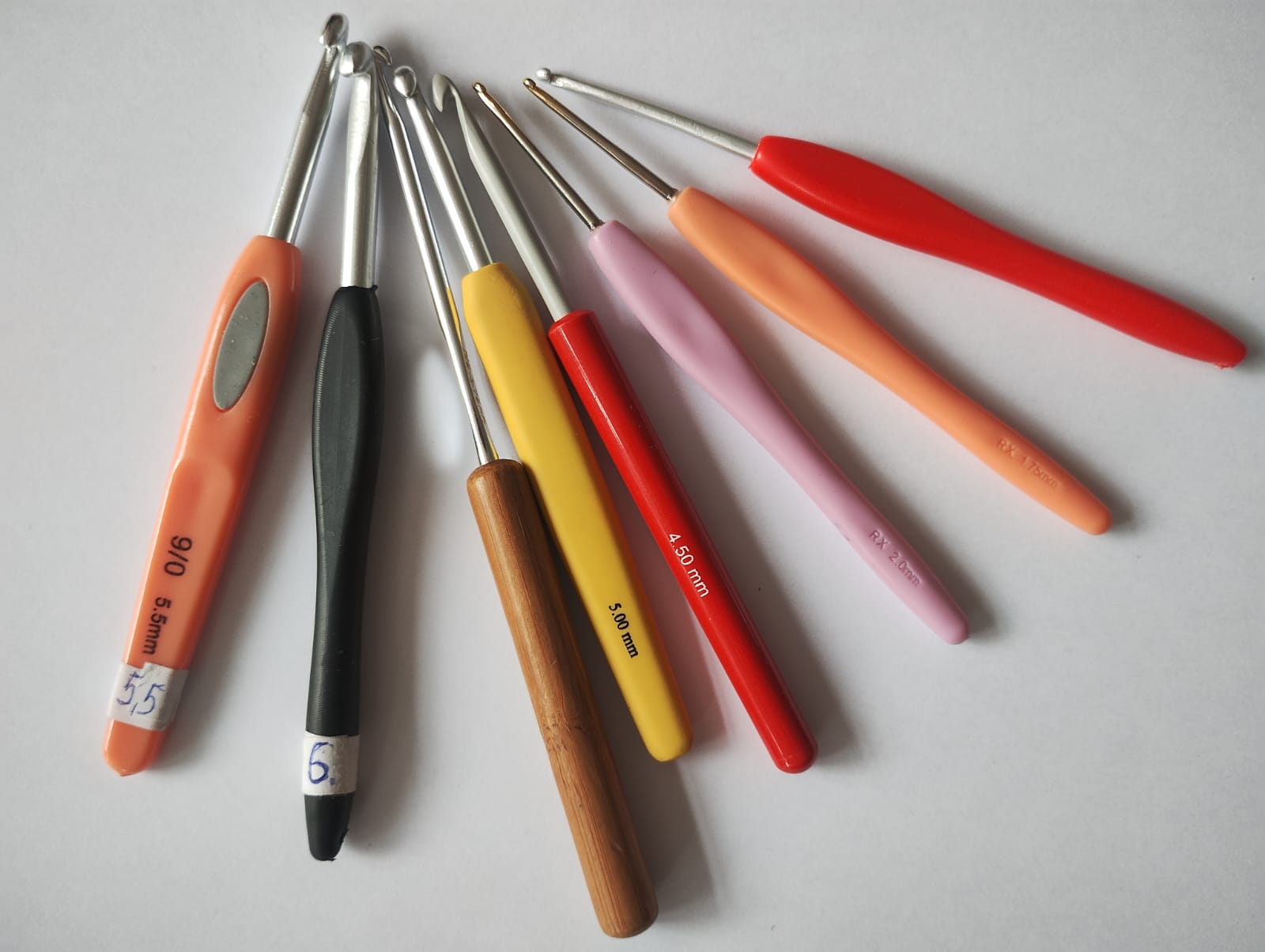 Crochet hooks with coloured handles and different millimetre size markings.